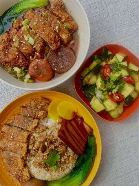 Two Formosa rice bowls with braised pork, greens, and a side of cucumber salad